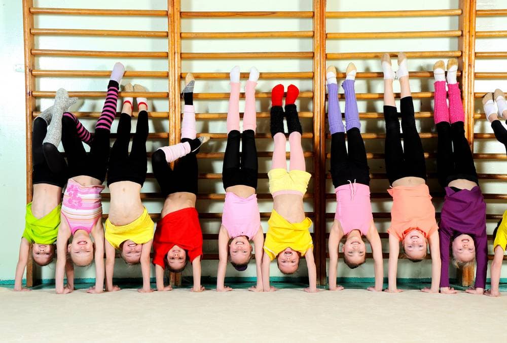 A gymnastics class on the floor mats