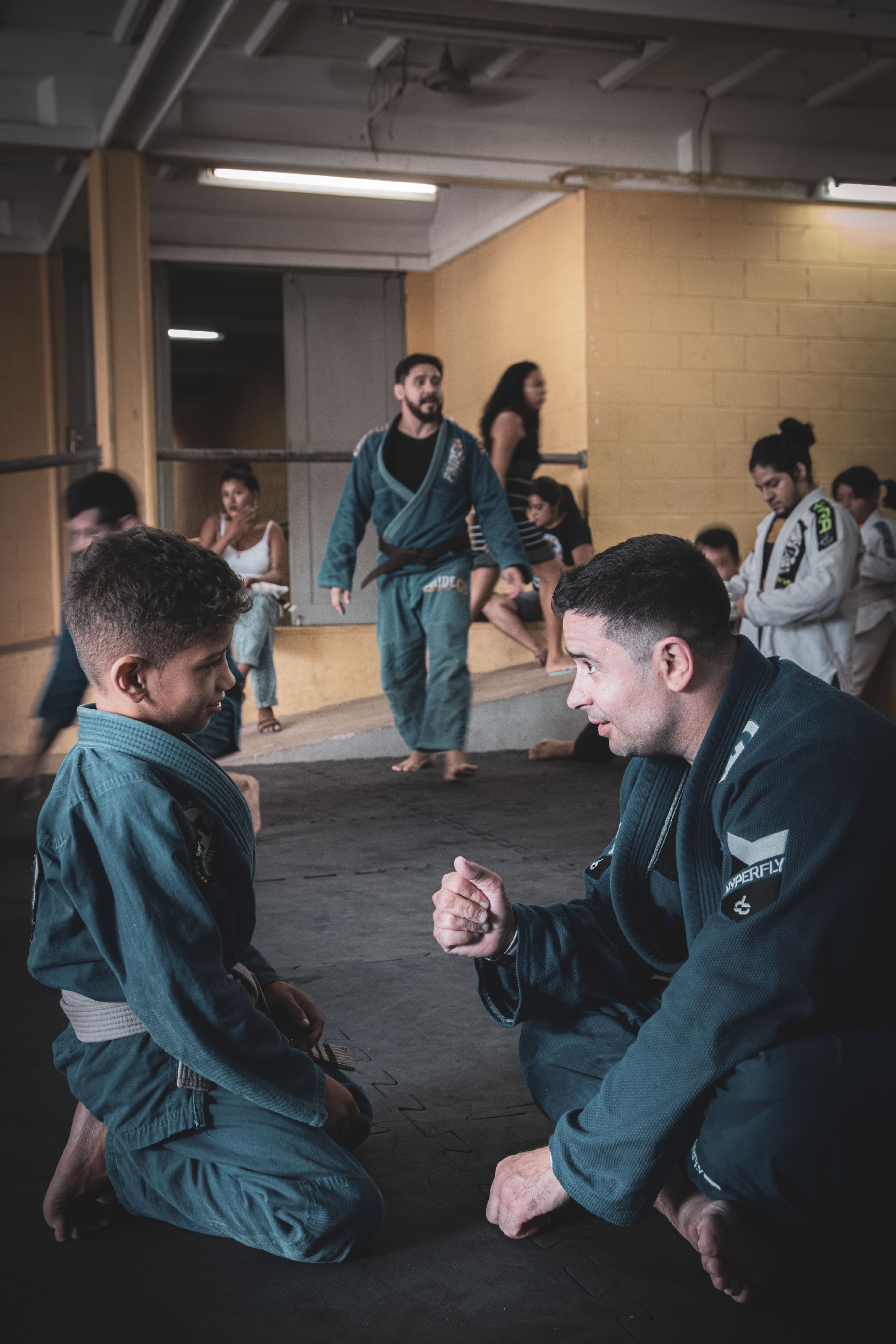 A martial arts coach leading a class of young students